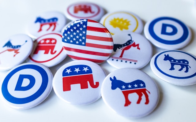A pile of political buttons sitting on top of a table