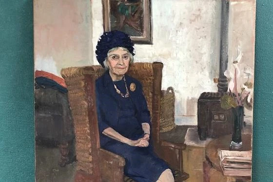 A painting of Vera Douie sat in an armchair