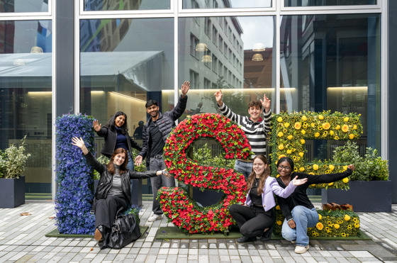 LSE students with the floral LSE letters on campus