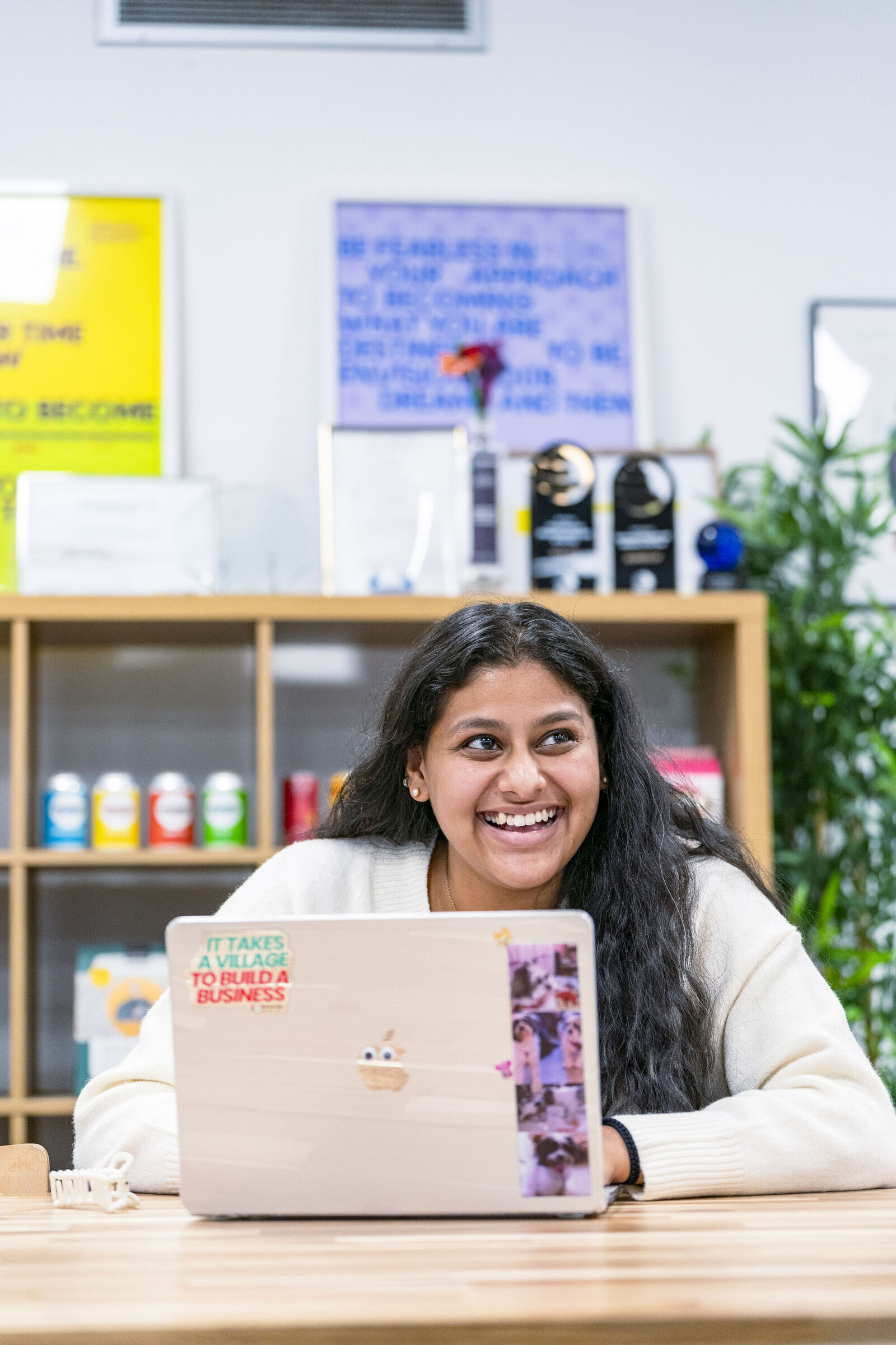 Student working on her laptop and smiling