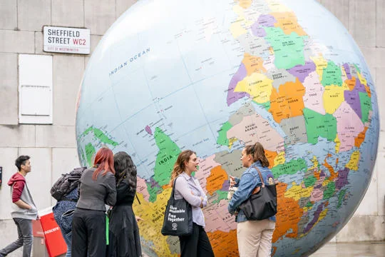 New students chatting next to LSE's Globe