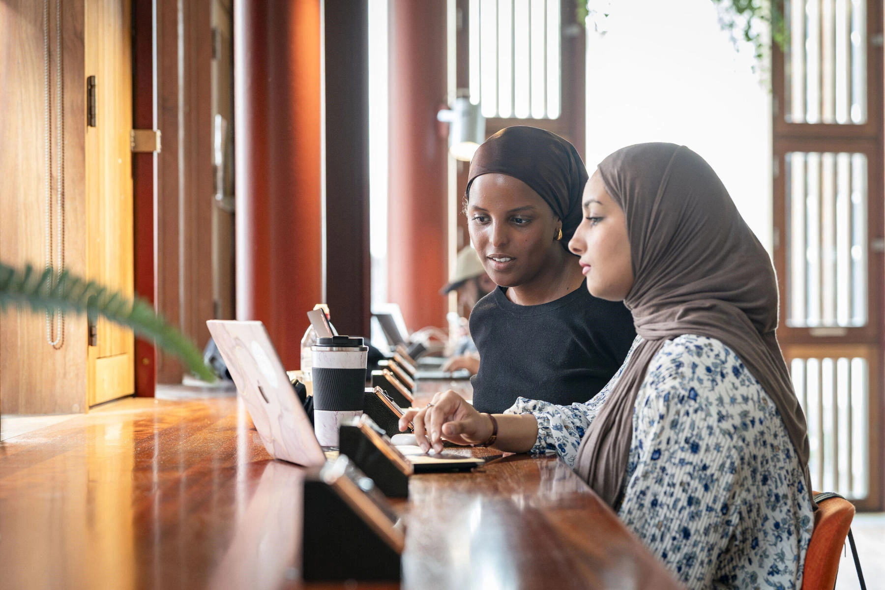 Two women look at a computer