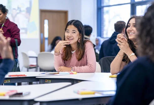 Student seated at a table during a group session