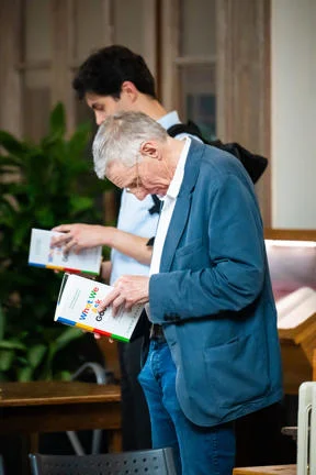 Crowd looks at book