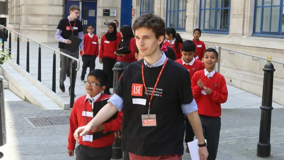 An LSE student leads a group of children