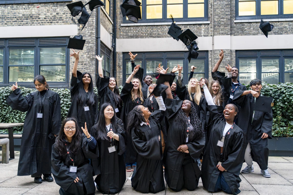 LSE Springboard WP programme participants celebrating in graduation caps and gowns