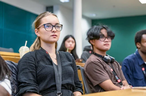 Two participants in a lecture theatre on a WP campus visit
