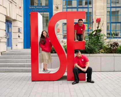 LSE Widening Participation Student Ambassadors posing with big red LSE letters
