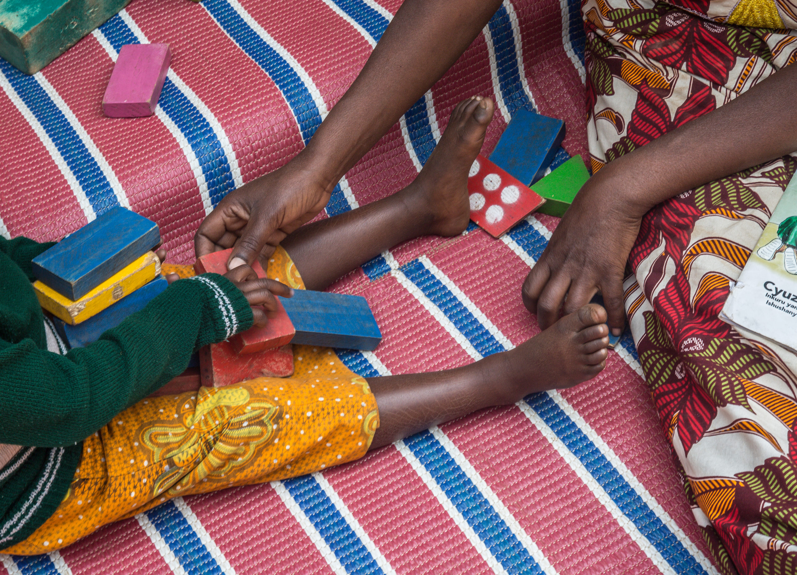 Cretaker from the Imbuto Foundation with a child in Rwanda.