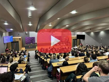 The YouTube symbol overlayed on a busy lecture theatre