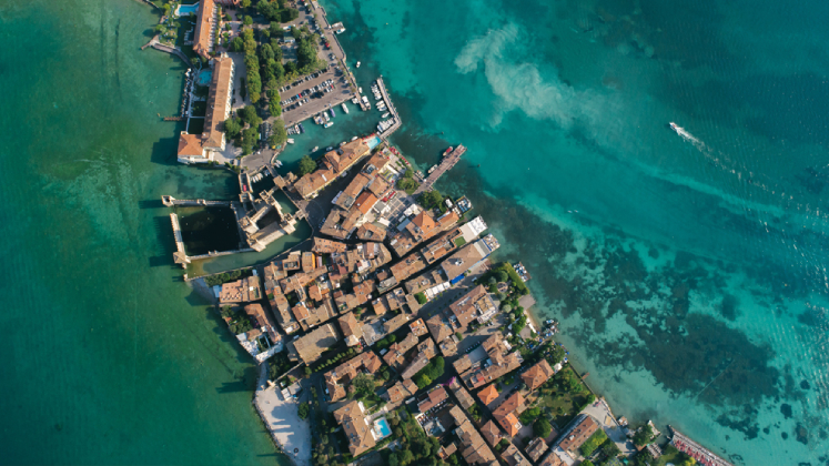 A string of houses spread out across the water in a tropical location