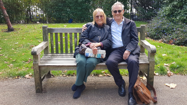 Phoebe and Tony Hall sit on the bench in Lincoln's Inn Fields where they got engaged