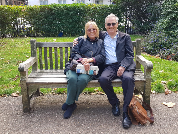 Phoebe (left) and Tony (right) sit on the bench they got engaged on in Lincoln's Inn Fields