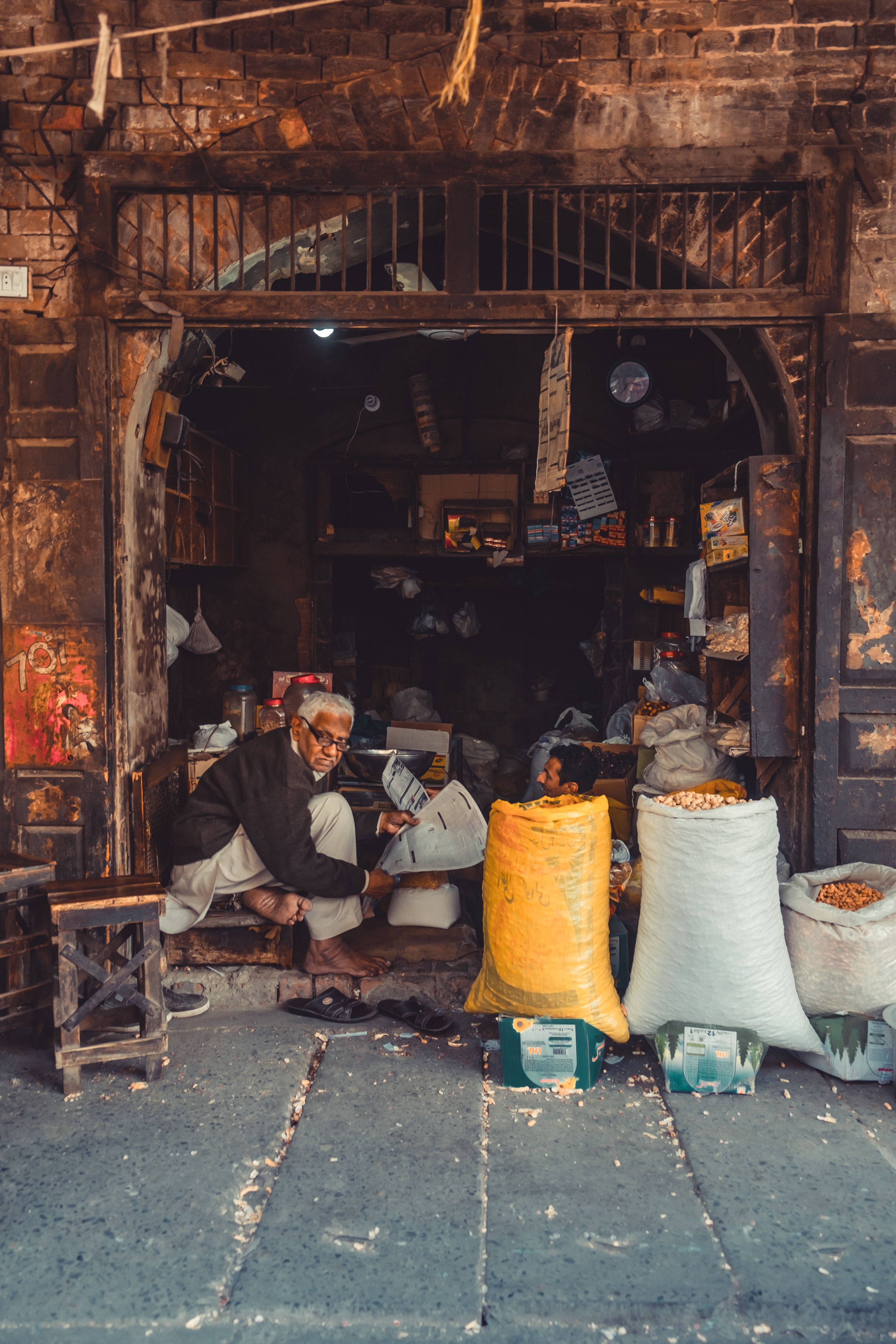 old man in shop doorway