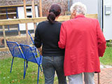 red_jacket_woman_chairs_carer_160x120