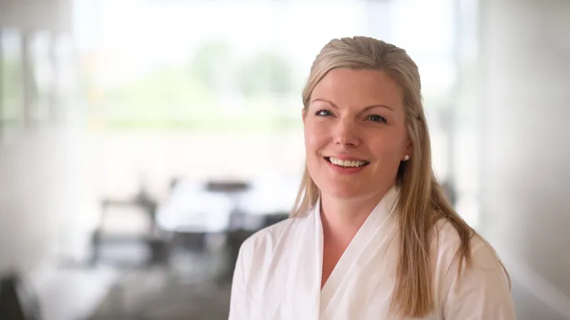 A blonde woman attending LSE Executive Education smiling at the camera Finance for Executives