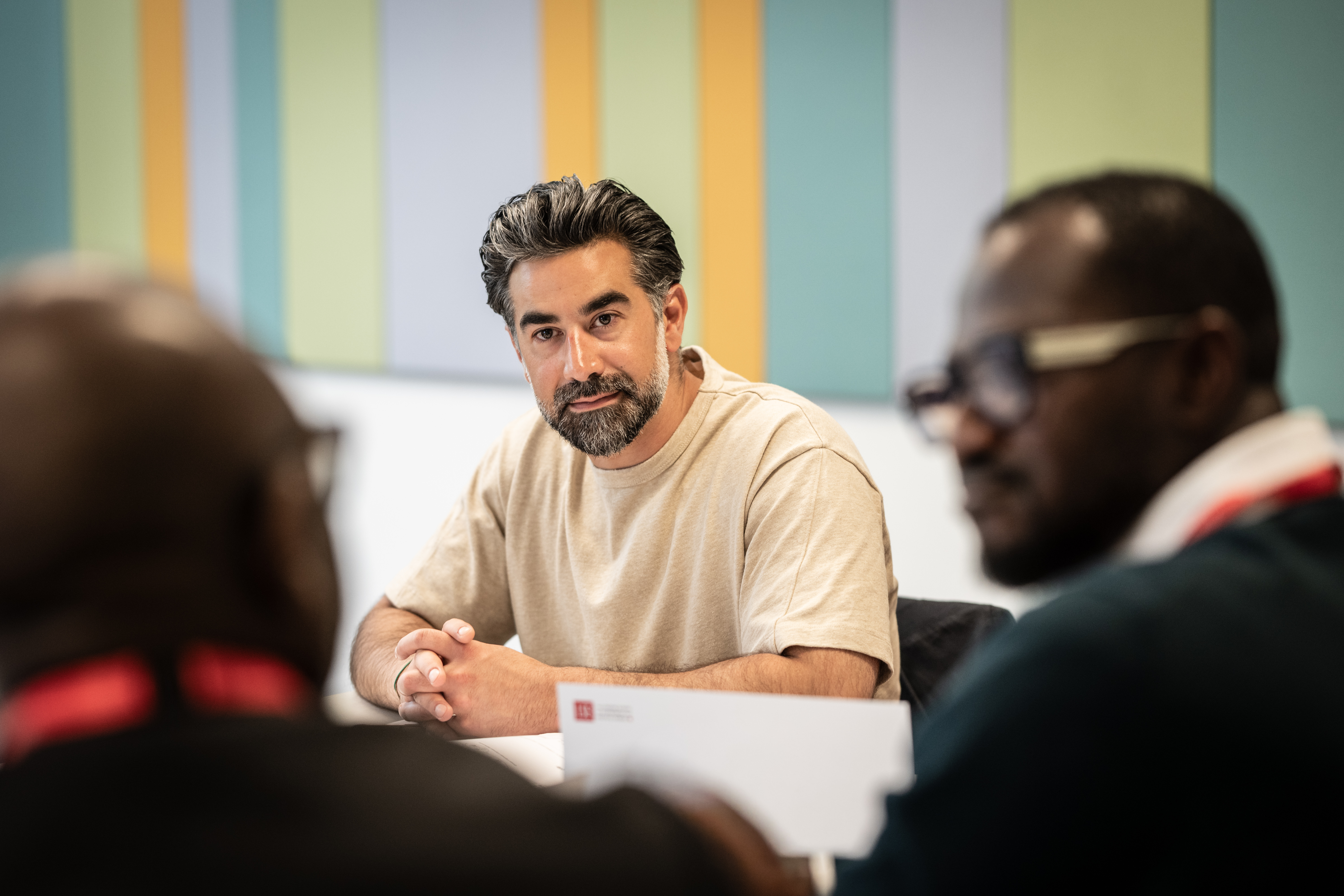 Man looking at two other men in front of him