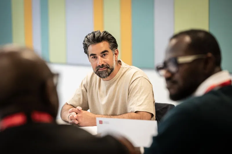 Man looking at two other men in front of him AI-First Strategy