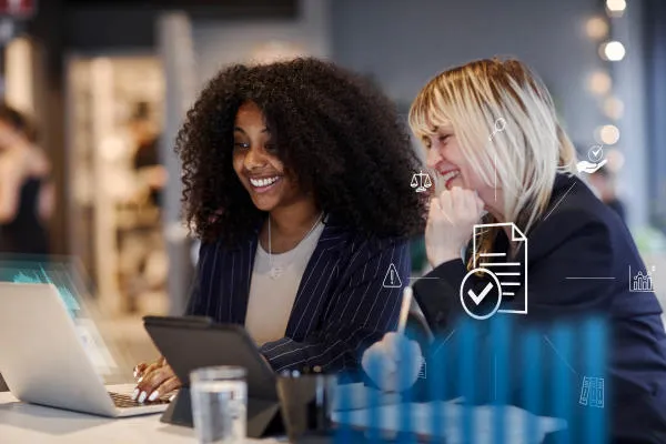 Two female professionals looking at a laptop Data-Driven Management: Analysis, Visualisation and Storytelling