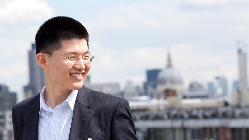 Student professional with city behind him