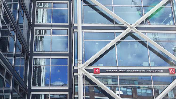 Abstract photograph of the LSE Government building with clouds reflected in the glass architecture.