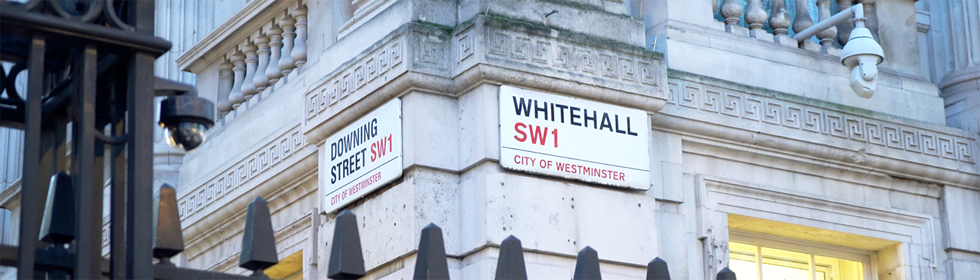 Photo of the street signs at the corner of Downing Street and Whitehall.