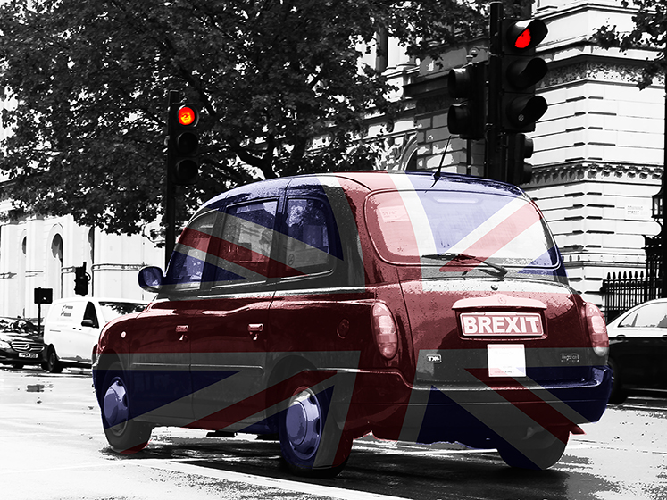 A London Taxi with a union jack flag on it.