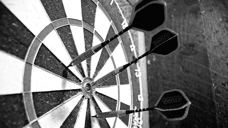 Darts in a dart board.