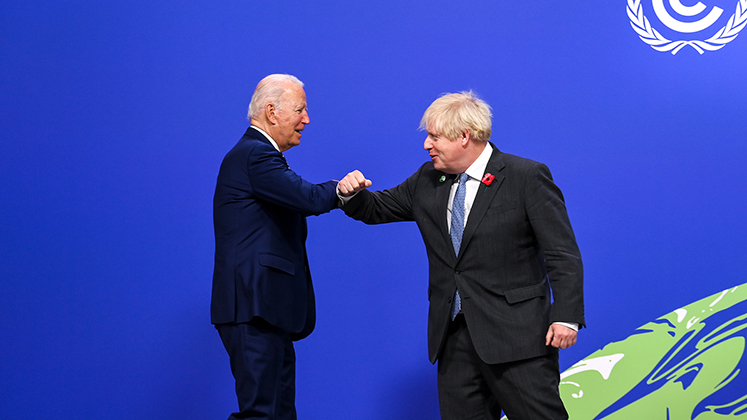 Joe Biden and Boris Johnson greet at COP26