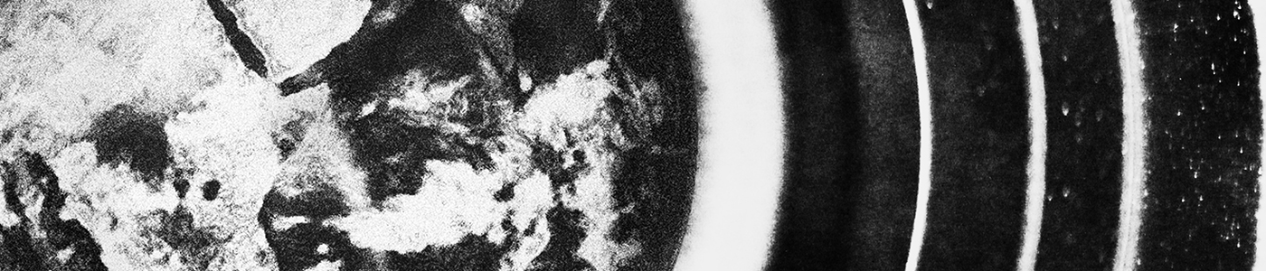 Abstract black and white image of the earth in the centre of a camera lens.