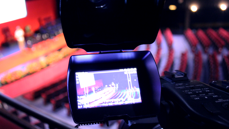 A close up of a video camera monitor filming inside a lecture theatre