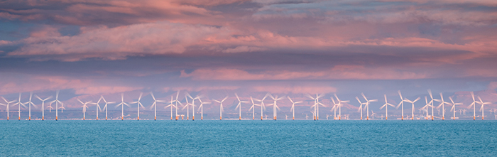 Wind Farm in motion at Sunset in the Solway Firth.