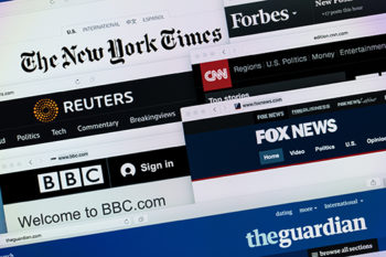 Photo shows a small selection of major global news websites