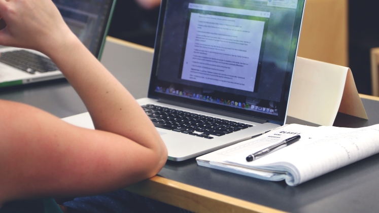 female-student-taking-notes-in-class-747x420