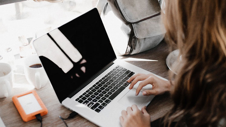 Woman typing on laptop