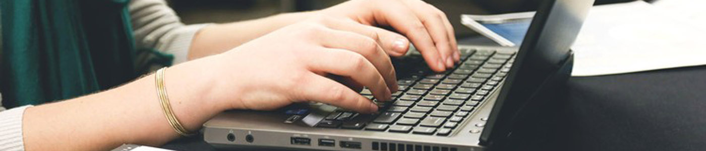 laptop-hands-writing-1400x300-header