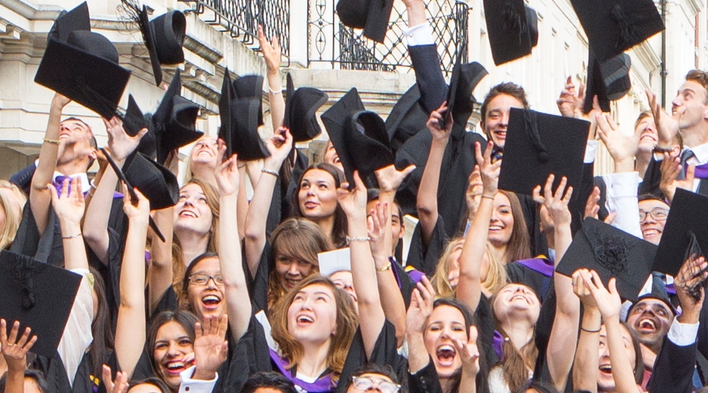 Alumni throwing hats in air