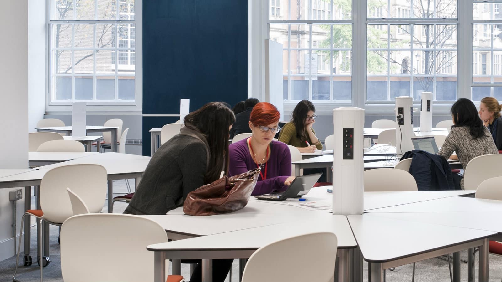 A librarian providing help to a student