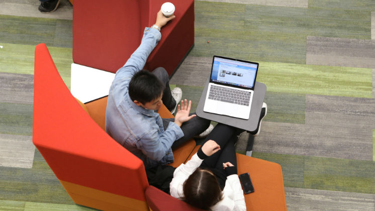 Students sitting on sofas and talking.