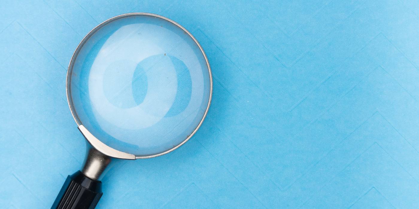 A magnifying glass on a blue background