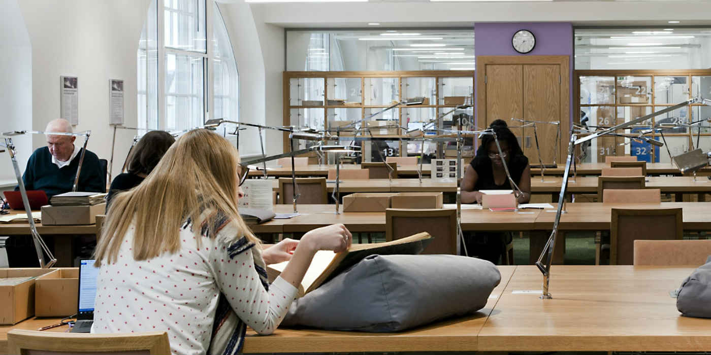 People sat using collections in the reading room.