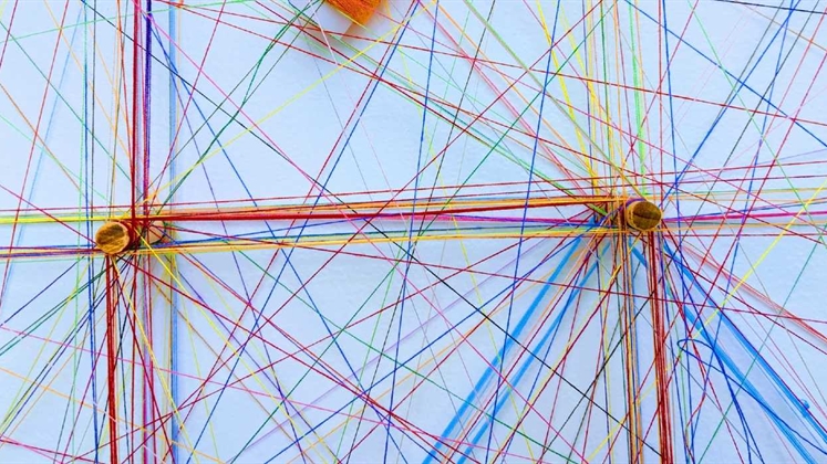 Many different pieces of thread all connecting around two points. An abstract representation of a network