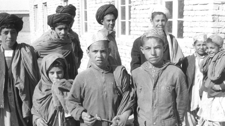 A balck and white photo of a group of boys and young men