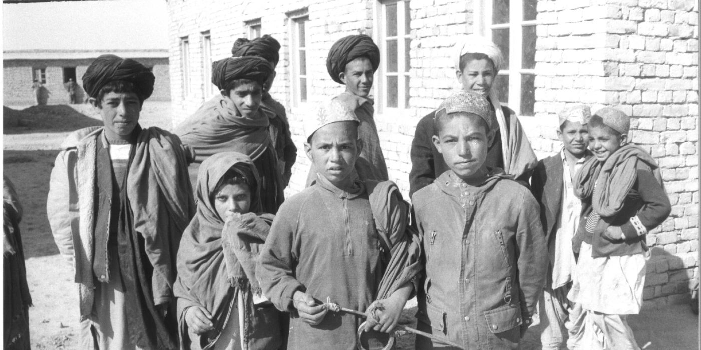 A balck and white photo of a group of boys and young men