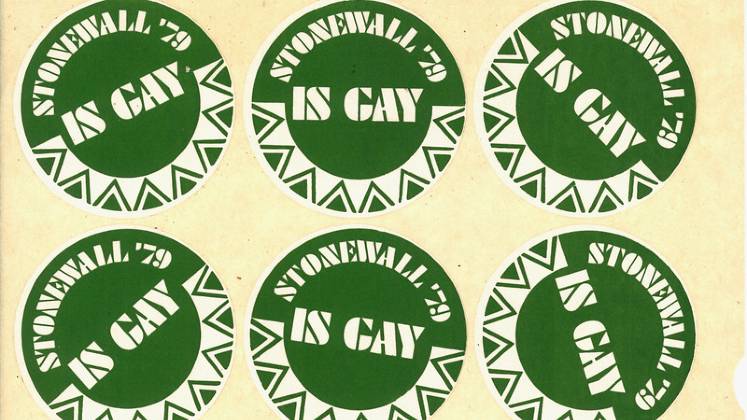 Green stickers that have "Stonewall' 79 Is Gay" written on them.