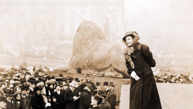 A woman talking to a crowd at Trafalgar Square in London.