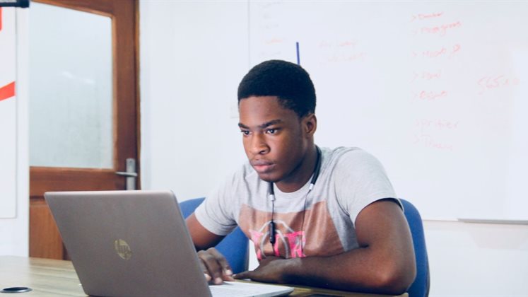 A man working on a laptop.