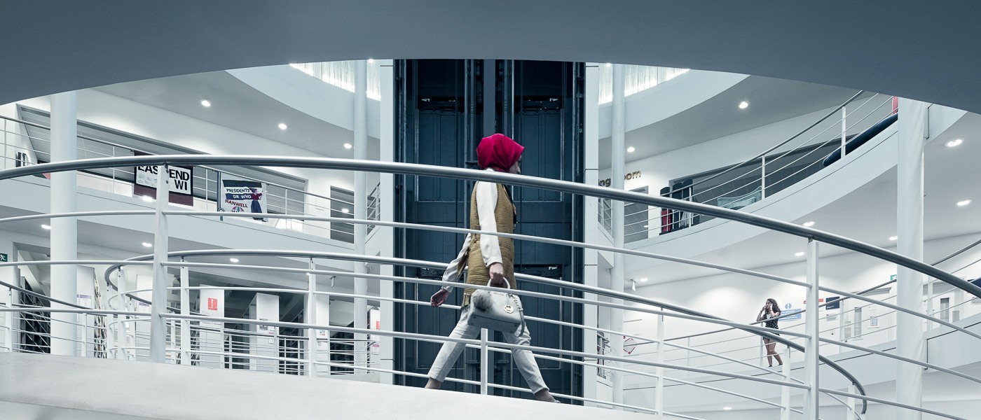 A person walking down the LSE Library spiral staircase