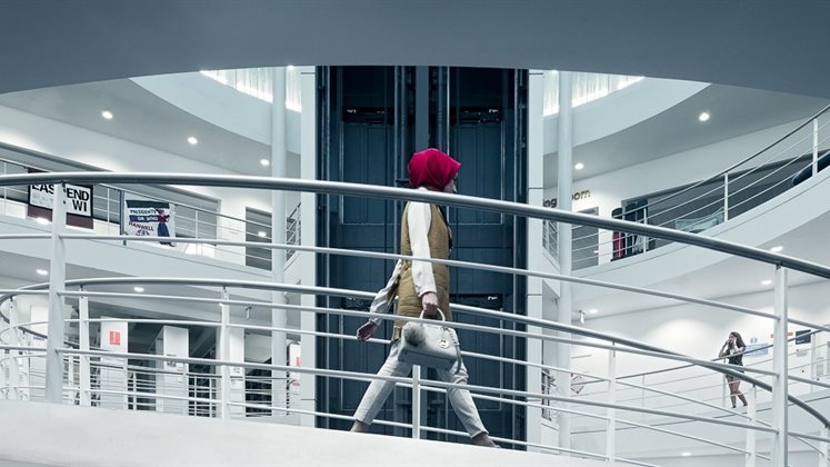 A person walking down the LSE Library spiral staircase