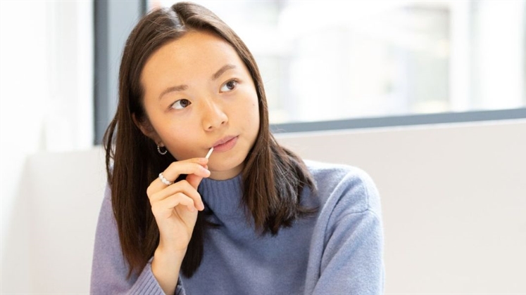 A student looking past the camera with their head slightly turned